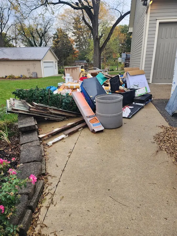 Dumpster being loaded with debris for Estate Cleanout Dumpster Rental in North Hanover